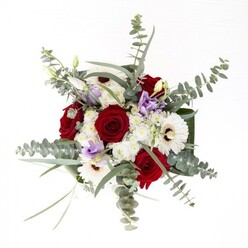 As a Belsize Park florist, I'd call this bouquet a celebration of subtle artistry and confident design. Each element stands distinct-white gerberas serve as the visual anchor, their creamy petals and dark centers reminiscent of the timeless allure found in Regent's Park blooms. Encircling them are rich, scarlet roses whose spiraled shapes speak of enduring commitments and cherished moments, perfect for marking weddings or new beginnings in this leafy London enclave. Wispy eucalyptus leaves arch overhead, their silvery sheen catching the shifting daylight that fills a North London studio, while lilac lisianthus introduce a touch of gentle modernity and grace, like the soft evening breeze over Belsize Park's rooftops. Fluffy white fillers and broad, dark foliage surround the arrangement, creating movement, texture, and a palpable freshness. With the clear glass vase displaying the stems and pristine water below, there's an invitation to trace each line and savor the heady, mingled fragrances. Whether for anniversaries, comfort, or welcoming a friend to new beginnings, this artful bouquet captures the trust and creative spirit that defines our Belsize Park community.